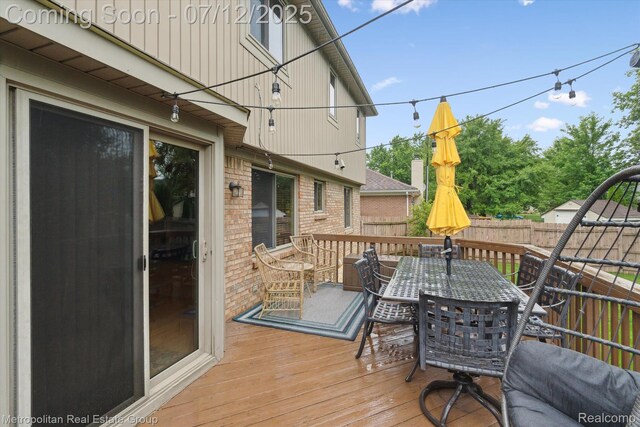 2129 Camelot Dr, Troy, MI 48083 - deck with outdoor dining area and a fenced backyard