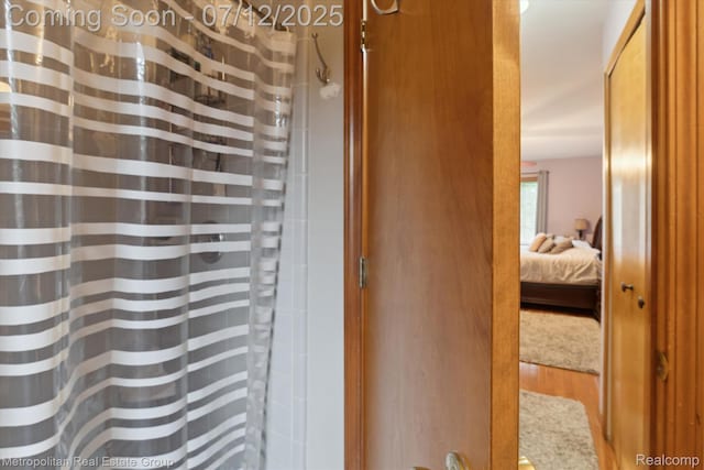 2129 Camelot Dr, Troy, MI 48083 - ensuite bathroom featuring wood finished floors and curtained shower