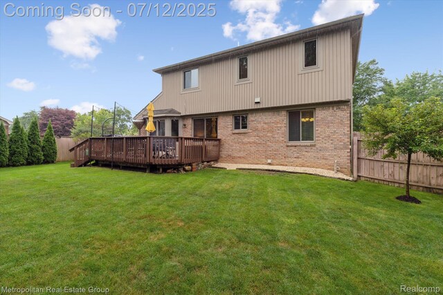 2129 Camelot Dr, Troy, MI 48083 - back of house with brick siding, a fenced backyard, and a deck
