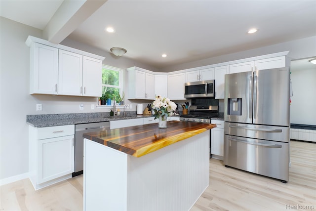11879 Secluded Ridge Dr, Byron, MI 48418 - kitchen featuring appliances with stainless steel finishes, wooden counters, white cabinets, and recessed lighting