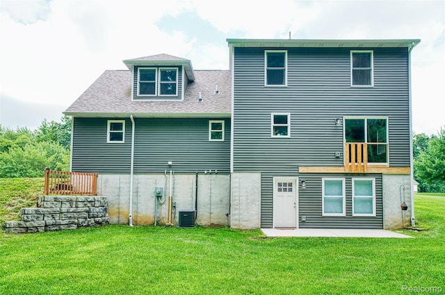 11879 Secluded Ridge Dr, Byron, MI 48418 - rear view of house featuring a yard, a patio, and roof with shingles