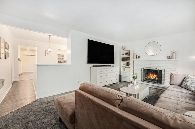 4649 Northview Ave NE, Grand Rapids, MI 49525 - living area featuring a brick fireplace and wood finished floors