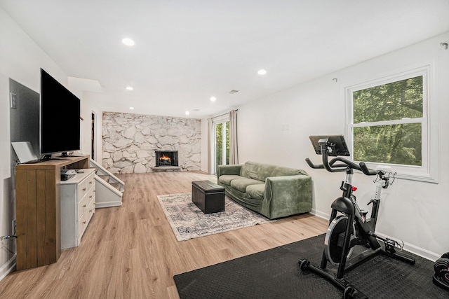 4649 Northview Ave NE, Grand Rapids, MI 49525 - exercise room featuring light wood-style floors, a fireplace, and recessed lighting
