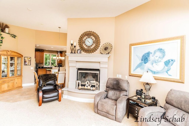 13025 Shaner Ave NE, Cedar Springs, MI 49319 - living room featuring a glass covered fireplace, a chandelier, and light colored carpet