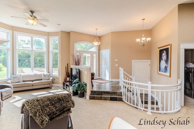 13025 Shaner Ave NE, Cedar Springs, MI 49319 - carpeted living area featuring washing machine and dryer, a chandelier, and ceiling fan