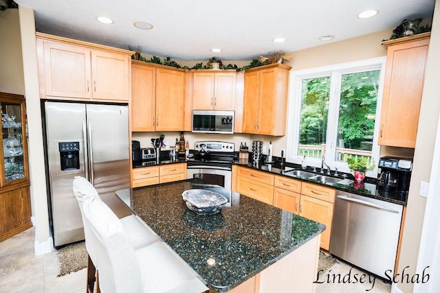 13025 Shaner Ave NE, Cedar Springs, MI 49319 - kitchen with stainless steel appliances, light brown cabinetry, recessed lighting, and dark stone counters