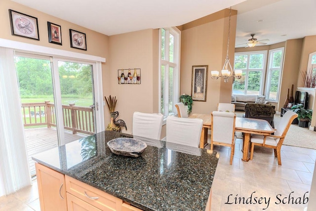 13025 Shaner Ave NE, Cedar Springs, MI 49319 - dining area with a chandelier, ceiling fan, and light tile patterned floors