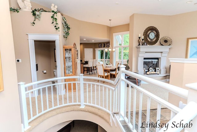 13025 Shaner Ave NE, Cedar Springs, MI 49319 - stairs with a glass covered fireplace and a chandelier