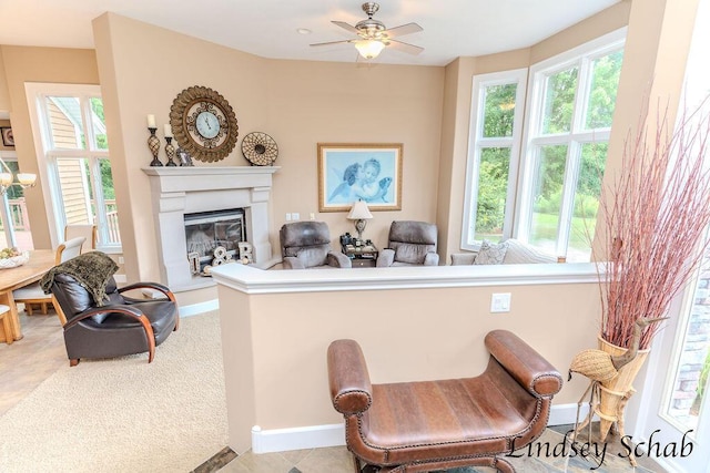 13025 Shaner Ave NE, Cedar Springs, MI 49319 - living room featuring healthy amount of natural light, a glass covered fireplace, and ceiling fan
