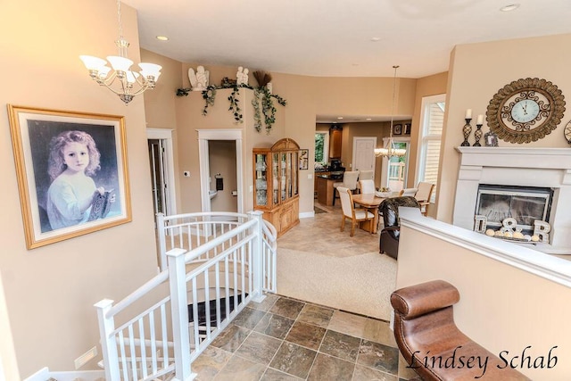 13025 Shaner Ave NE, Cedar Springs, MI 49319 - interior space with a chandelier, a glass covered fireplace, recessed lighting, and dark stone finish flooring