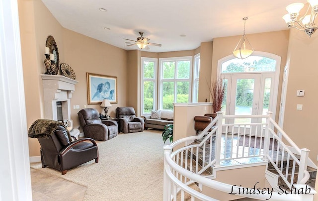13025 Shaner Ave NE, Cedar Springs, MI 49319 - living area featuring healthy amount of natural light, carpet flooring, a fireplace, and a chandelier