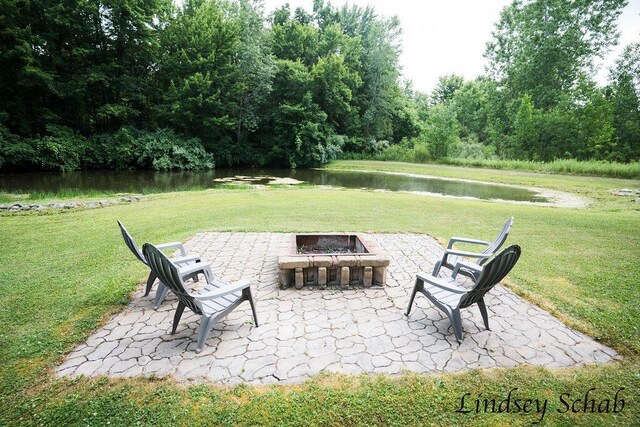 13025 Shaner Ave NE, Cedar Springs, MI 49319 - view of patio featuring a water view and a fire pit