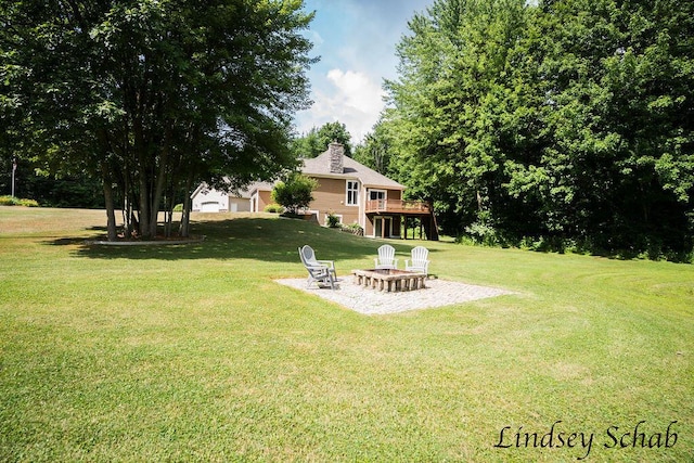 13025 Shaner Ave NE, Cedar Springs, MI 49319 - view of green lawn featuring an outdoor fire pit, a wooden deck, and a patio area