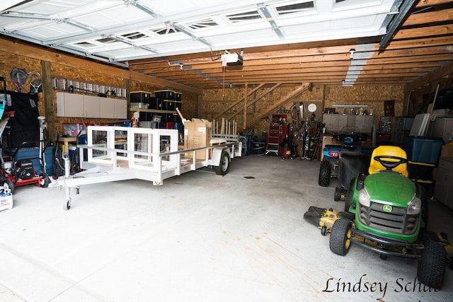 13025 Shaner Ave NE, Cedar Springs, MI 49319 - garage with a garage door opener and a workshop area