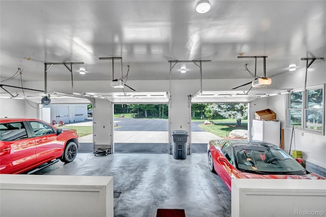 6728 Bowers Rd, Imlay City, MI 48444 - garage with a garage door opener and freestanding refrigerator