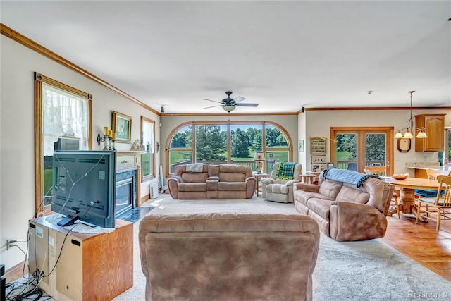 6728 Bowers Rd, Imlay City, MI 48444 - living room with ornamental molding, a chandelier, a fireplace with flush hearth, a ceiling fan, and plenty of natural light