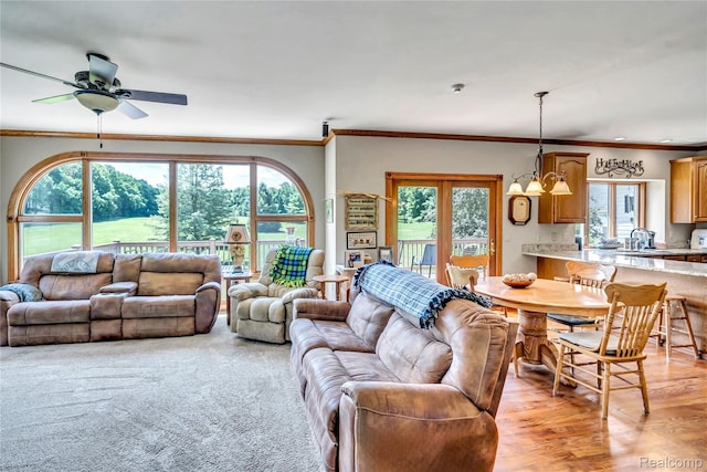 6728 Bowers Rd, Imlay City, MI 48444 - living room featuring healthy amount of natural light, crown molding, ceiling fan, and a chandelier