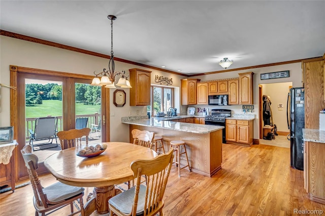 6728 Bowers Rd, Imlay City, MI 48444 - kitchen featuring black appliances, a peninsula, crown molding, light wood-style flooring, and brown cabinets