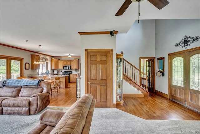 6728 Bowers Rd, Imlay City, MI 48444 - living area featuring a ceiling fan, stairs, french doors, a chandelier, and light wood finished floors