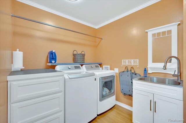 1647 Higley Rd, Lapeer, MI 48446 - laundry room with washer and dryer, ornamental molding, and light wood-style floors