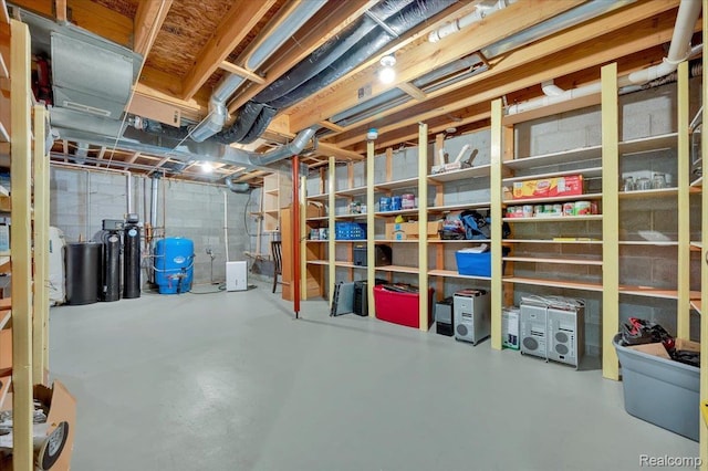 1647 Higley Rd, Lapeer, MI 48446 - unfinished basement featuring a water pressure tank and a water softener system