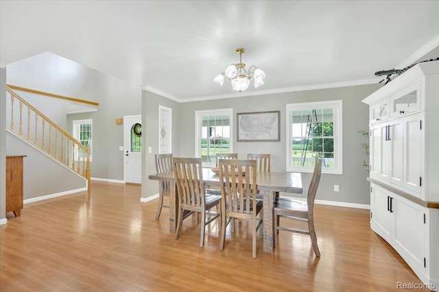 1647 Higley Rd, Lapeer, MI 48446 - dining area featuring a chandelier, stairs, plenty of natural light, crown molding, and light wood finished floors