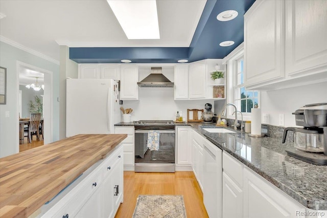 1647 Higley Rd, Lapeer, MI 48446 - kitchen with white appliances, wall chimney exhaust hood, butcher block counters, white cabinetry, and crown molding