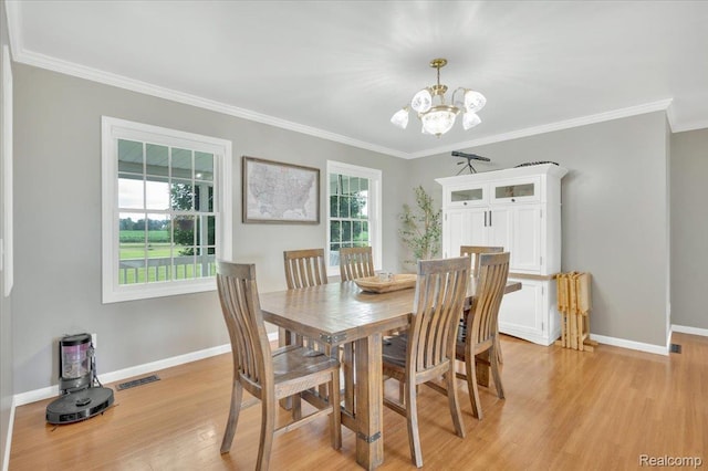 1647 Higley Rd, Lapeer, MI 48446 - dining room with a chandelier, light wood-style floors, and ornamental molding