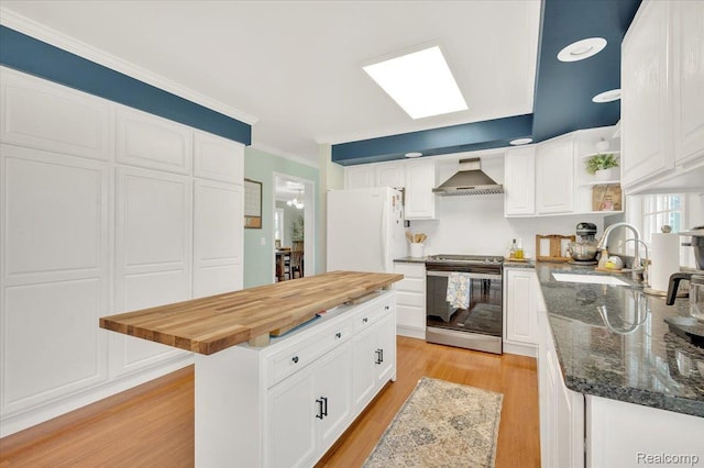 1647 Higley Rd, Lapeer, MI 48446 - kitchen featuring electric stove, wall chimney range hood, freestanding refrigerator, wooden counters, and open shelves