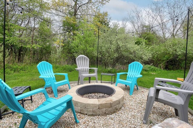 7229 Lakeview Ave, South Haven, MI 49090 - view of patio with a fire pit and a view of trees