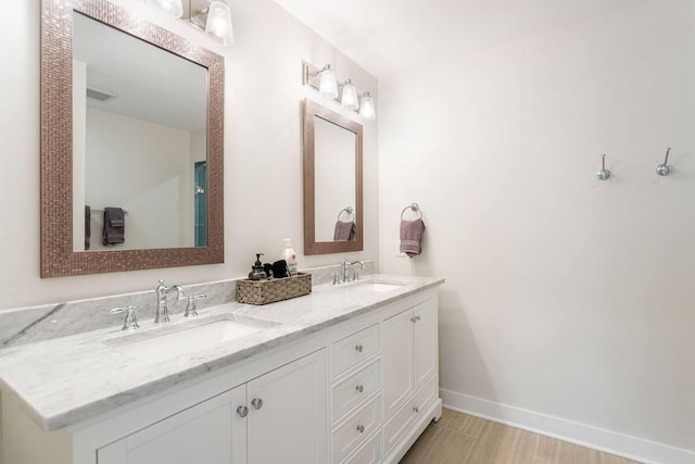 7229 Lakeview Ave, South Haven, MI 49090 - bathroom featuring double vanity and baseboards