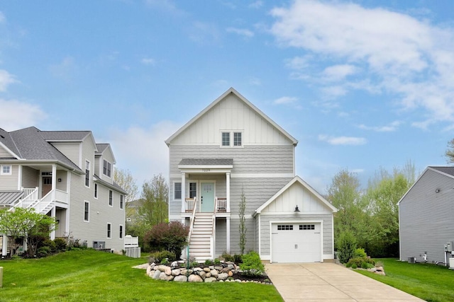 7229 Lakeview Ave, South Haven, MI 49090 - view of front of house with board and batten siding, stairway, concrete driveway, and a front yard