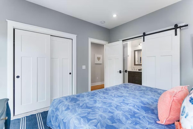 7229 Lakeview Ave, South Haven, MI 49090 - bedroom featuring a barn door, a closet, recessed lighting, and ensuite bathroom