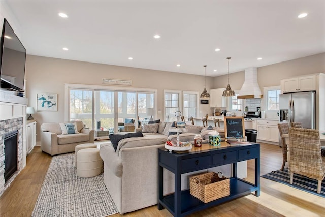 7229 Lakeview Ave, South Haven, MI 49090 - living room with a stone fireplace, recessed lighting, and light wood finished floors