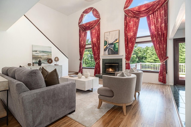 8411 Reese Ln, Ann Arbor, MI 48103 - living area with a tile fireplace, wood finished floors, and a towering ceiling