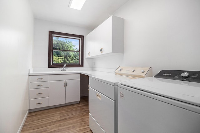 8411 Reese Ln, Ann Arbor, MI 48103 - washroom featuring washer and dryer, cabinet space, and light wood finished floors