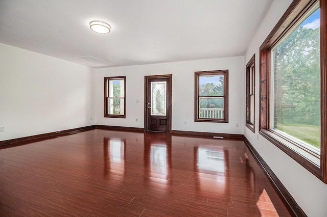 8411 Reese Ln, Ann Arbor, MI 48103 - empty room with healthy amount of natural light and dark wood-style flooring