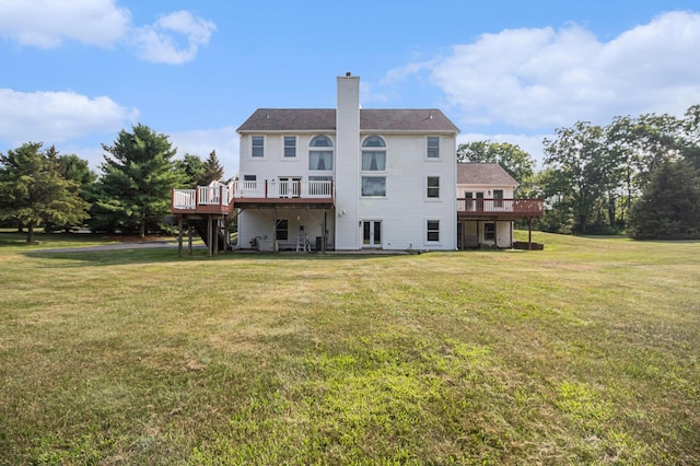 8411 Reese Ln, Ann Arbor, MI 48103 - rear view of property with a deck, a lawn, and a chimney