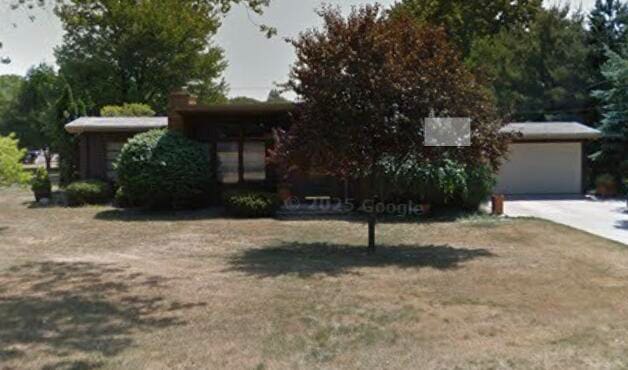 349 Dunham Dr, Battle Creek, MI 49015 - obstructed view of property featuring concrete driveway and an attached garage