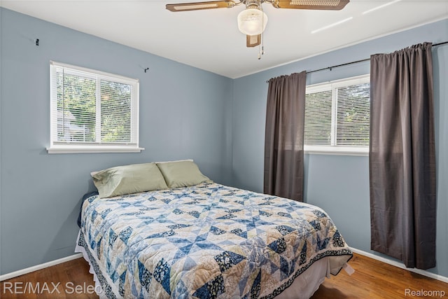 4391 Ashlawn Dr, Flint, MI 48507 - bedroom with multiple windows, wood finished floors, and a ceiling fan
