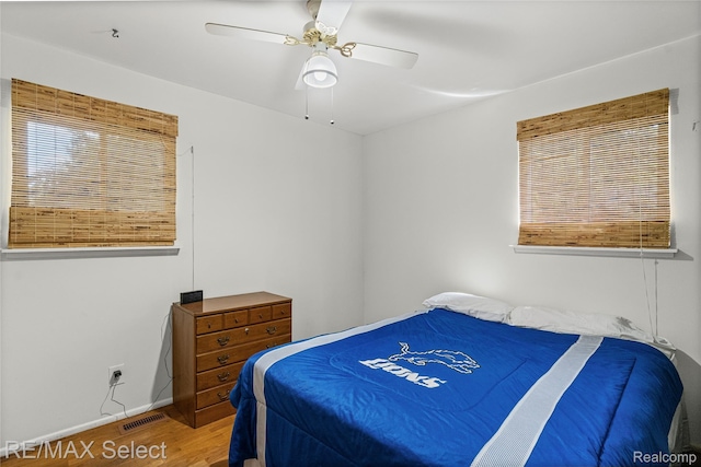 4391 Ashlawn Dr, Flint, MI 48507 - bedroom featuring wood finished floors, a ceiling fan, and multiple windows