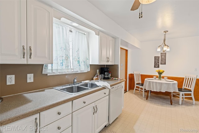 4391 Ashlawn Dr, Flint, MI 48507 - kitchen with dishwasher, white cabinetry, wainscoting, hanging light fixtures, and light countertops
