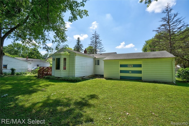 4391 Ashlawn Dr, Flint, MI 48507 - rear view of house with a lawn and a chimney