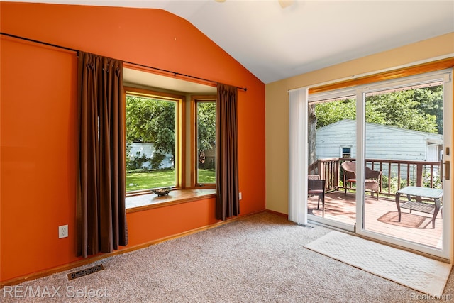 4391 Ashlawn Dr, Flint, MI 48507 - spare room featuring vaulted ceiling and carpet