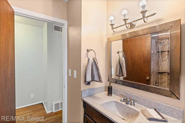 4391 Ashlawn Dr, Flint, MI 48507 - full bath with wood finished floors, vanity, and a shower