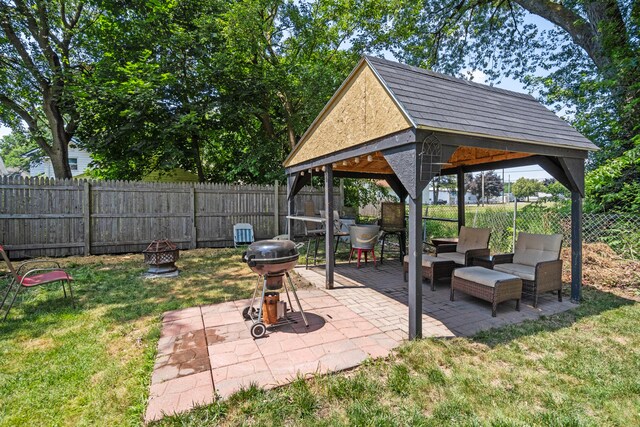 210 S Forbes St, Jackson, MI 49203 - fenced backyard featuring a gazebo, a patio, an outdoor living space with a fire pit, and area for grilling