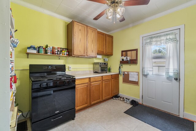 210 S Forbes St, Jackson, MI 49203 - kitchen featuring black gas range oven, ornamental molding, a ceiling fan, light countertops, and brown cabinetry