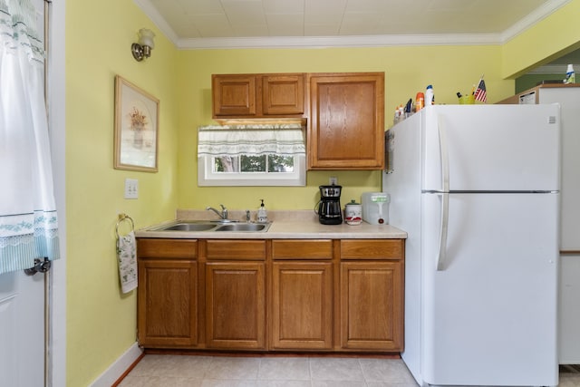 210 S Forbes St, Jackson, MI 49203 - kitchen featuring freestanding refrigerator, brown cabinets, light countertops, and ornamental molding