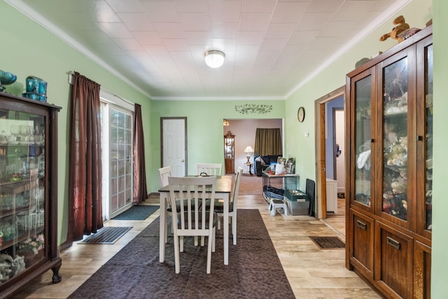 210 S Forbes St, Jackson, MI 49203 - dining space with crown molding and light wood-style flooring