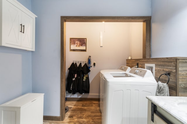 210 S Forbes St, Jackson, MI 49203 - laundry area featuring independent washer and dryer, cabinet space, and wood finished floors